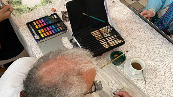 man kleurt een tekening in